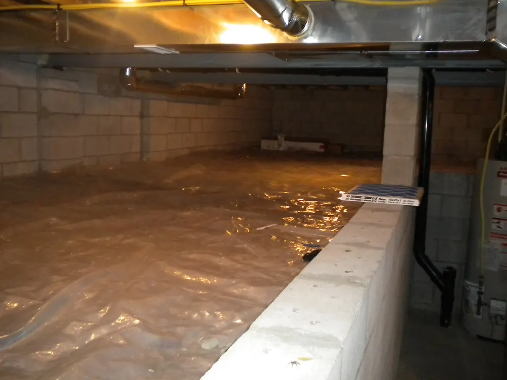 Crawl space with plastic over the ground and block walls