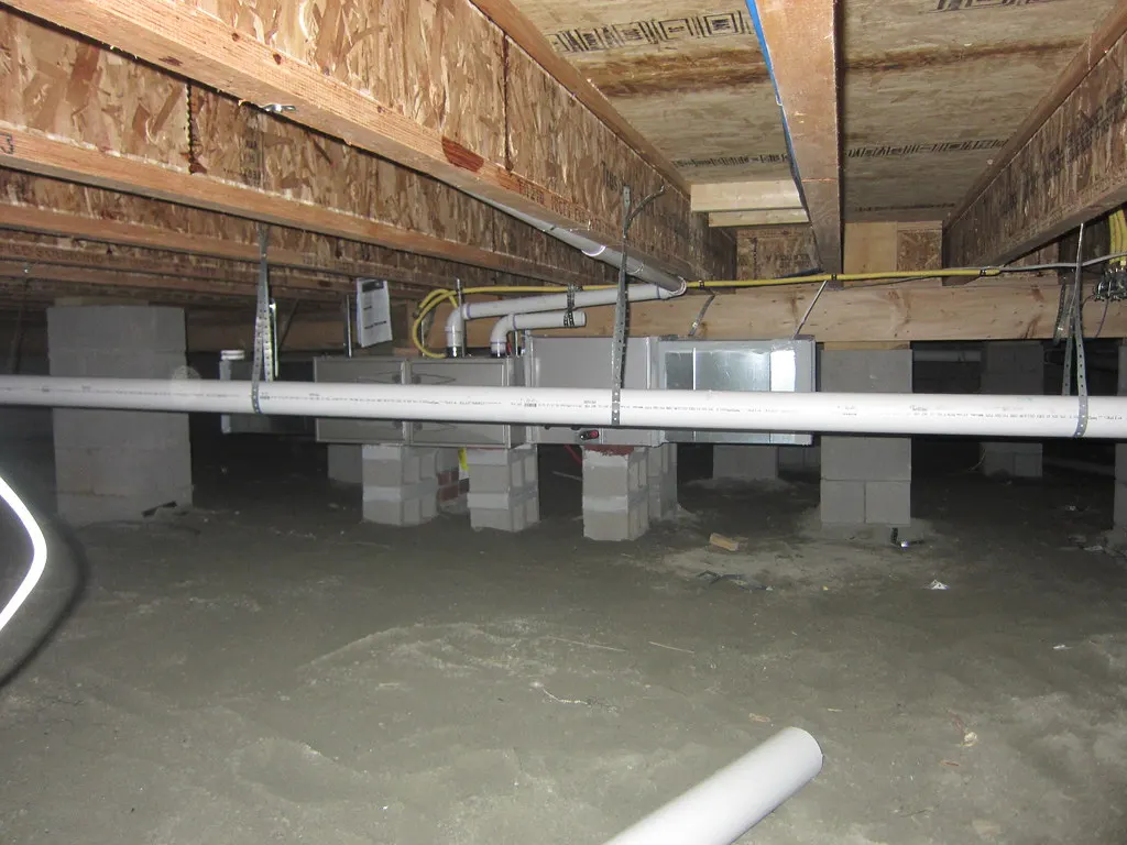 Crawl space framing and support piers seen during an inspection